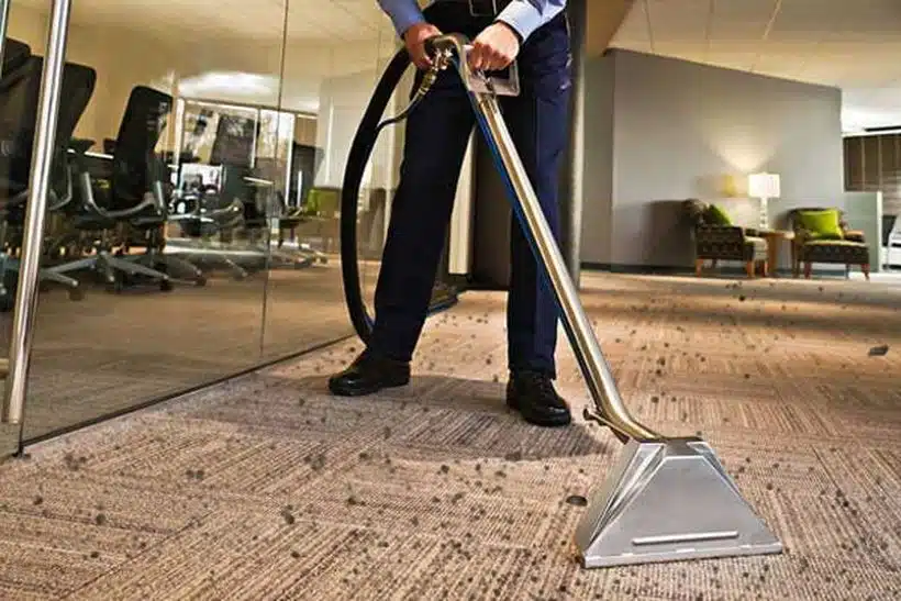 A man is standing with steam machine on his hand